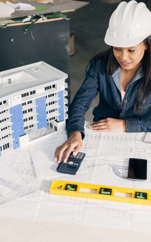 african-american-lady-safety-helmet-sitting-near-model-building-min (1)
